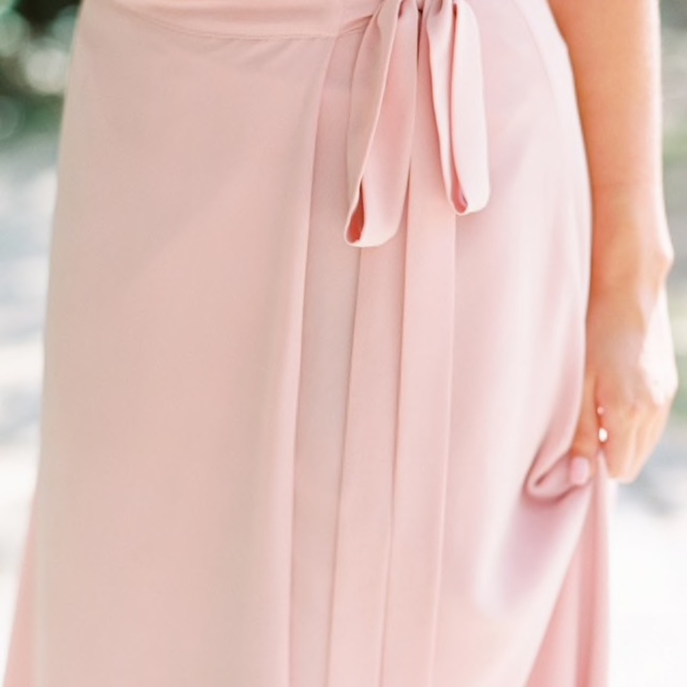 Cream lace blouse and floor length wrap skirt.